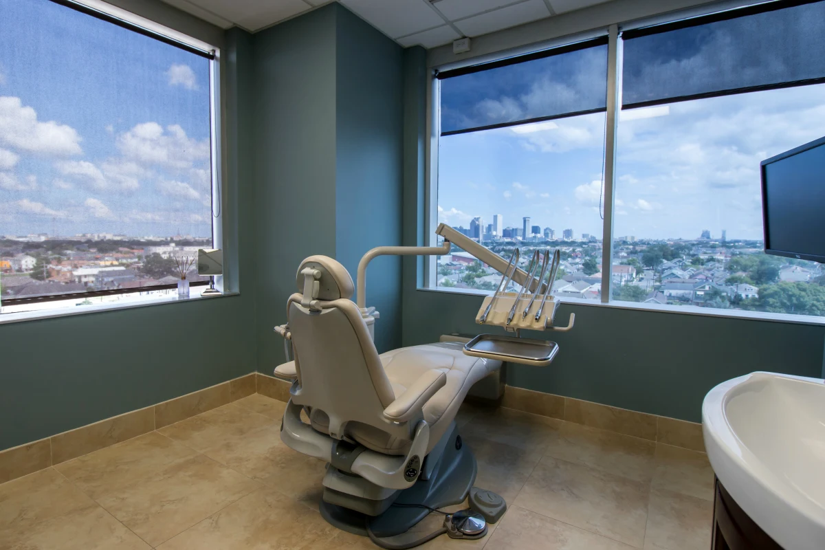 Modern dental treatment room with New Orleans skyline view at NOLA Smiles