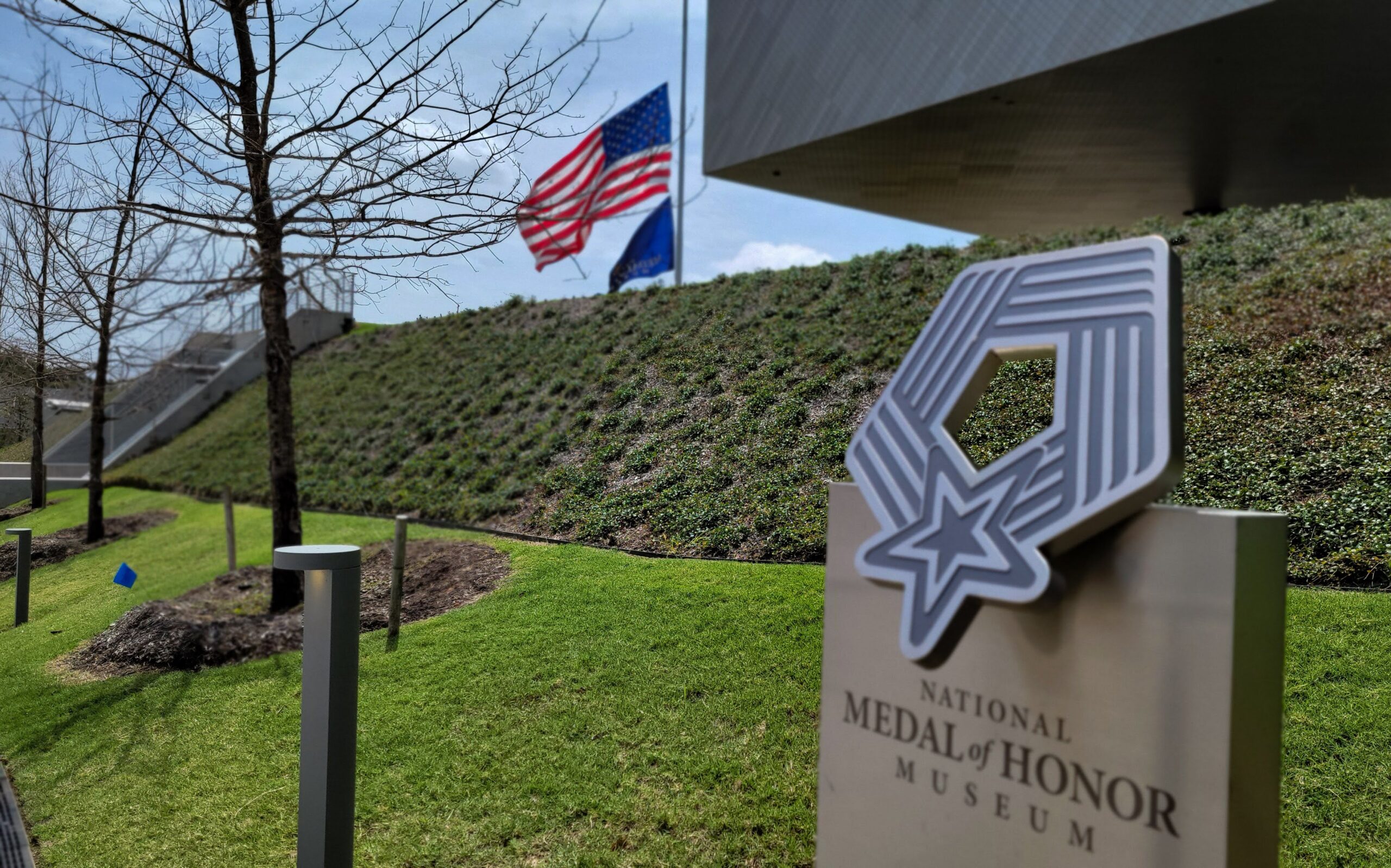 The museum entrance sign beside the U.S. flag