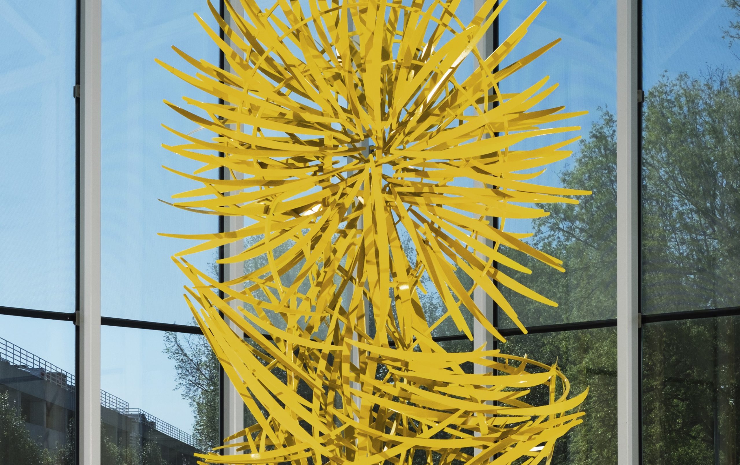Close up of the abstract yellow Waterfall of Light sculpture in the indoor fountain at GSP.